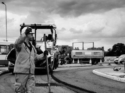 Worker Calling Paver